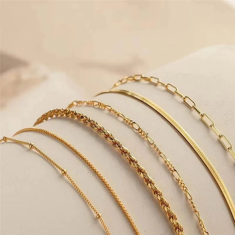 Set of gold necklaces on a light background