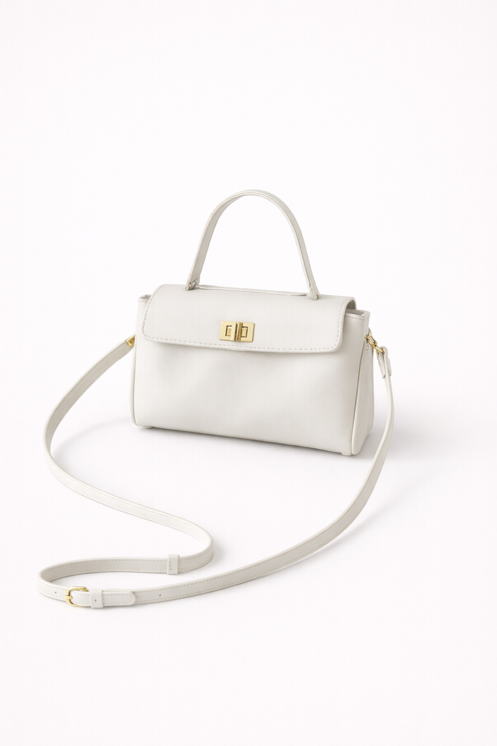 White handbag with a gold clasp on a white background