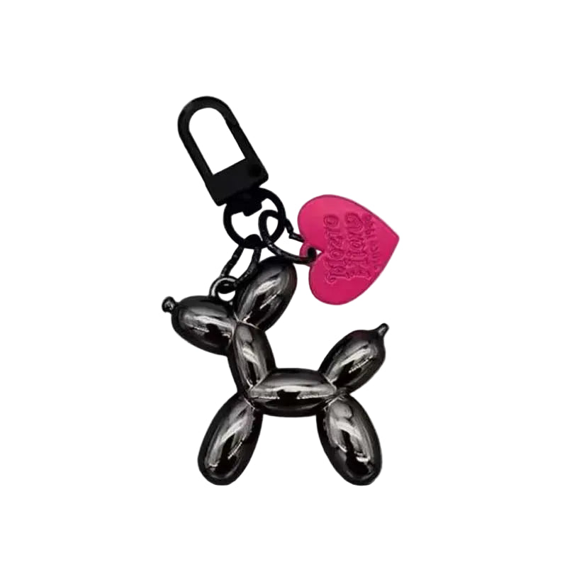 Keychain shaped like a balloon dog with a pink heart tag on a light gray background