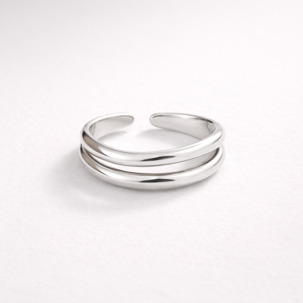 Silver ring with three bands on a white background