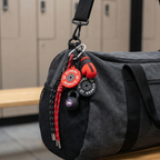 Gray duffel bag with fitness equipment attached in a locker room setting