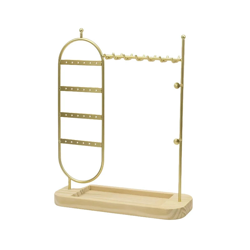 Gold jewelry stand with multiple tiers and a tray on a white background