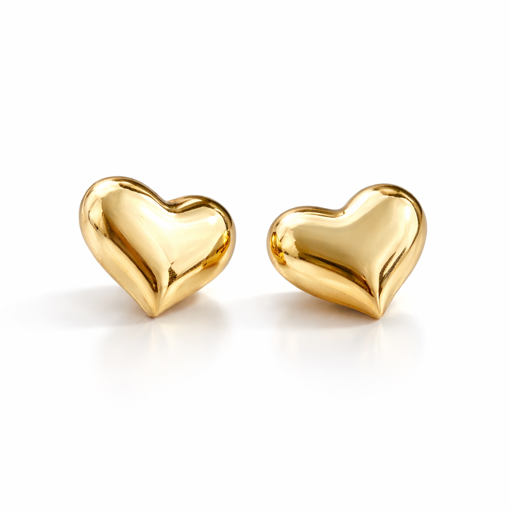 Gold heart-shaped earrings on a white background