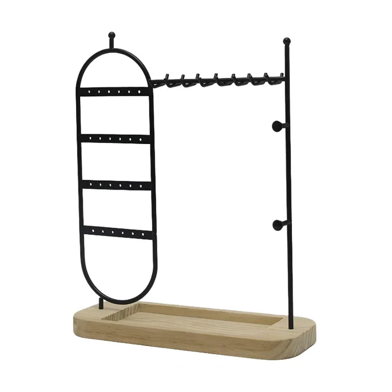 Jewelry organizer with black metal hooks and a wooden base on a white background