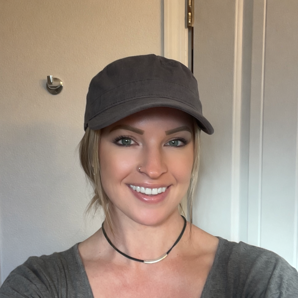 Woman wearing a gray cap and gray shirt indoors