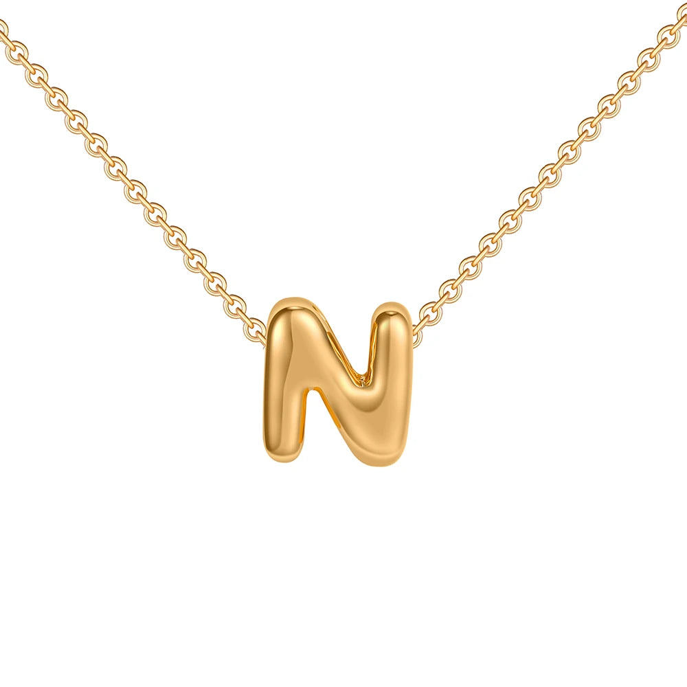 Gold necklace with a 'N' pendant on a white background