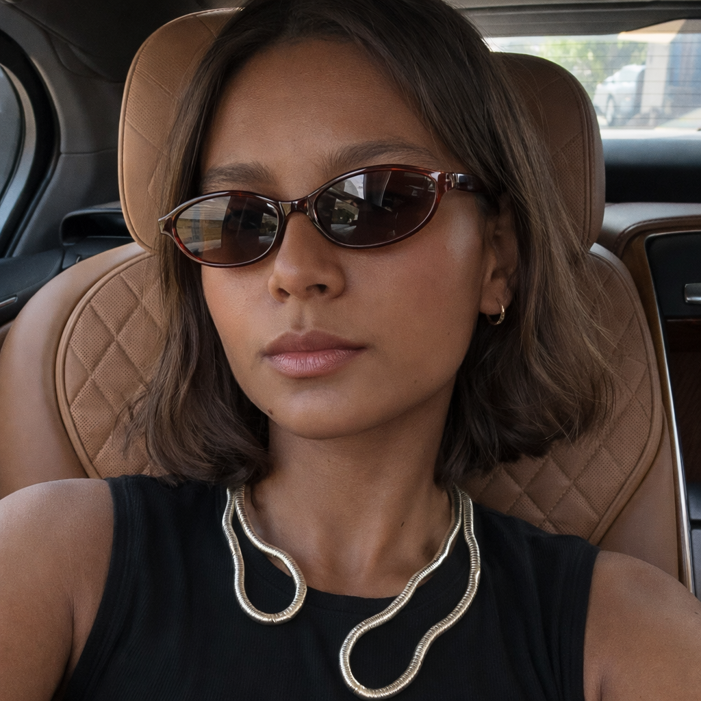 Woman wearing sunglasses sitting in a car