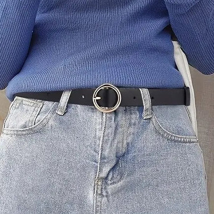 Person wearing a blue sweater and light blue jeans with a black belt featuring a gold buckle.