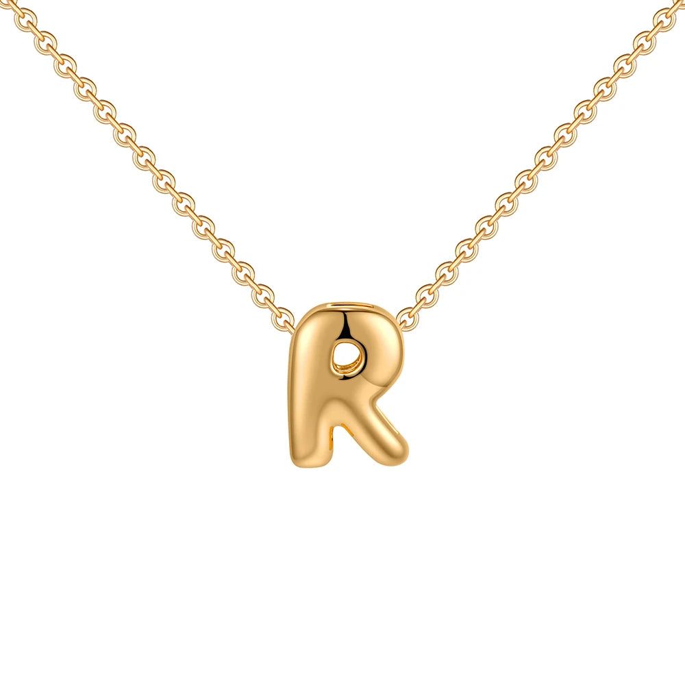 Gold necklace with a letter 'R' pendant on a white background
