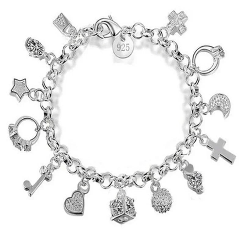 Silver charm bracelet with various charms on a white background