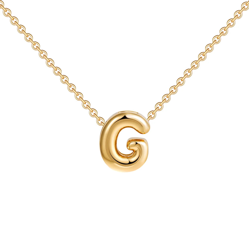 Gold necklace with a circular pendant on a white background