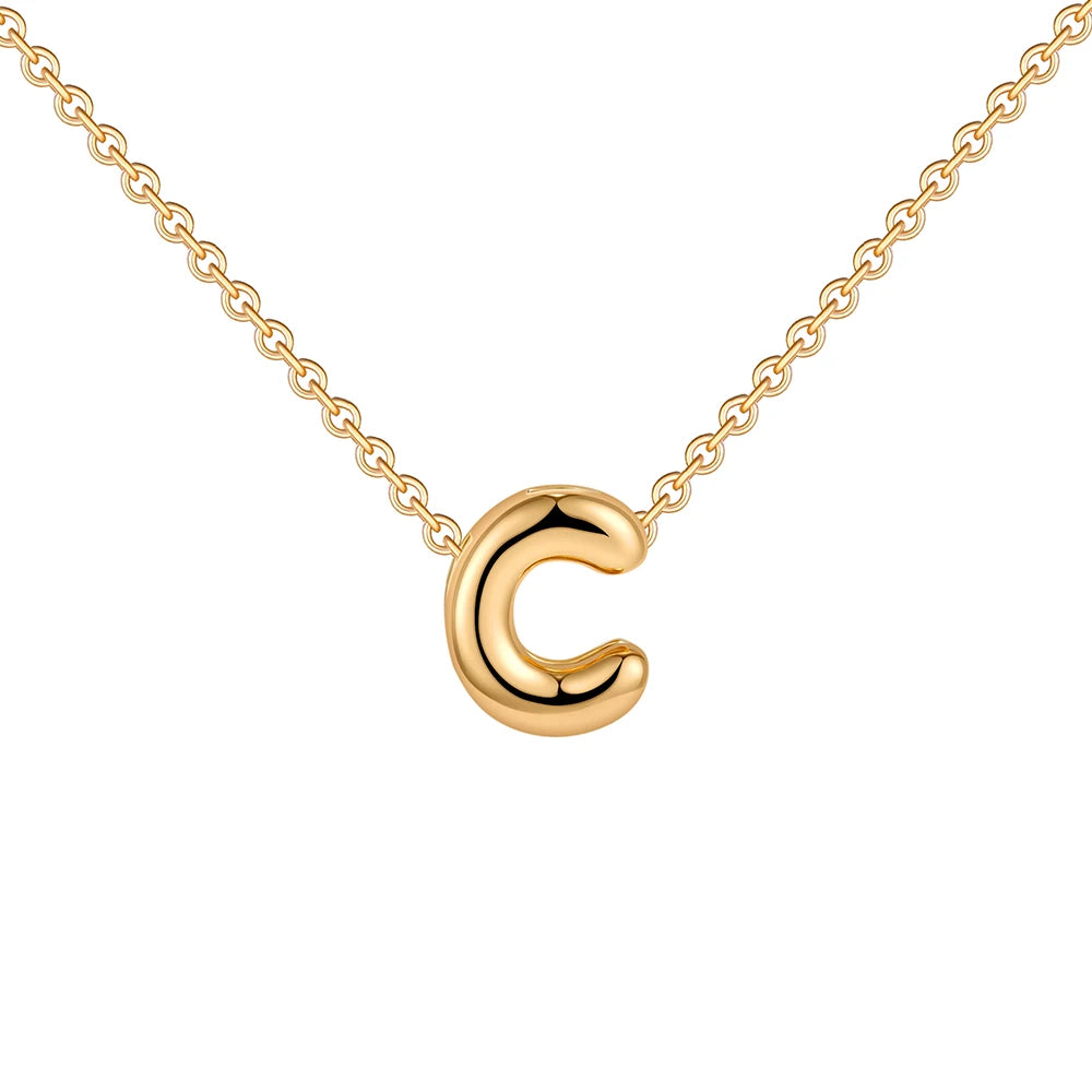 Gold necklace with a crescent moon pendant on a white background