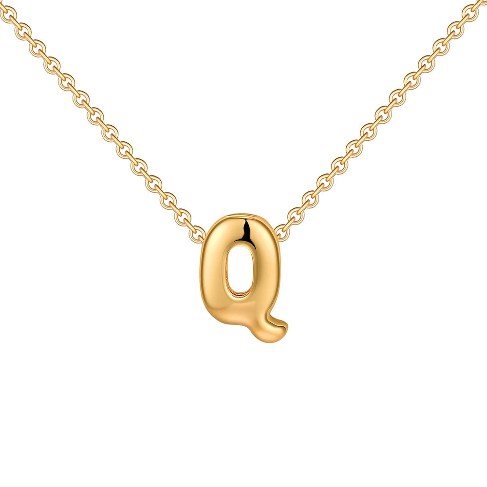 Gold necklace with a letter 'q' pendant on a white background