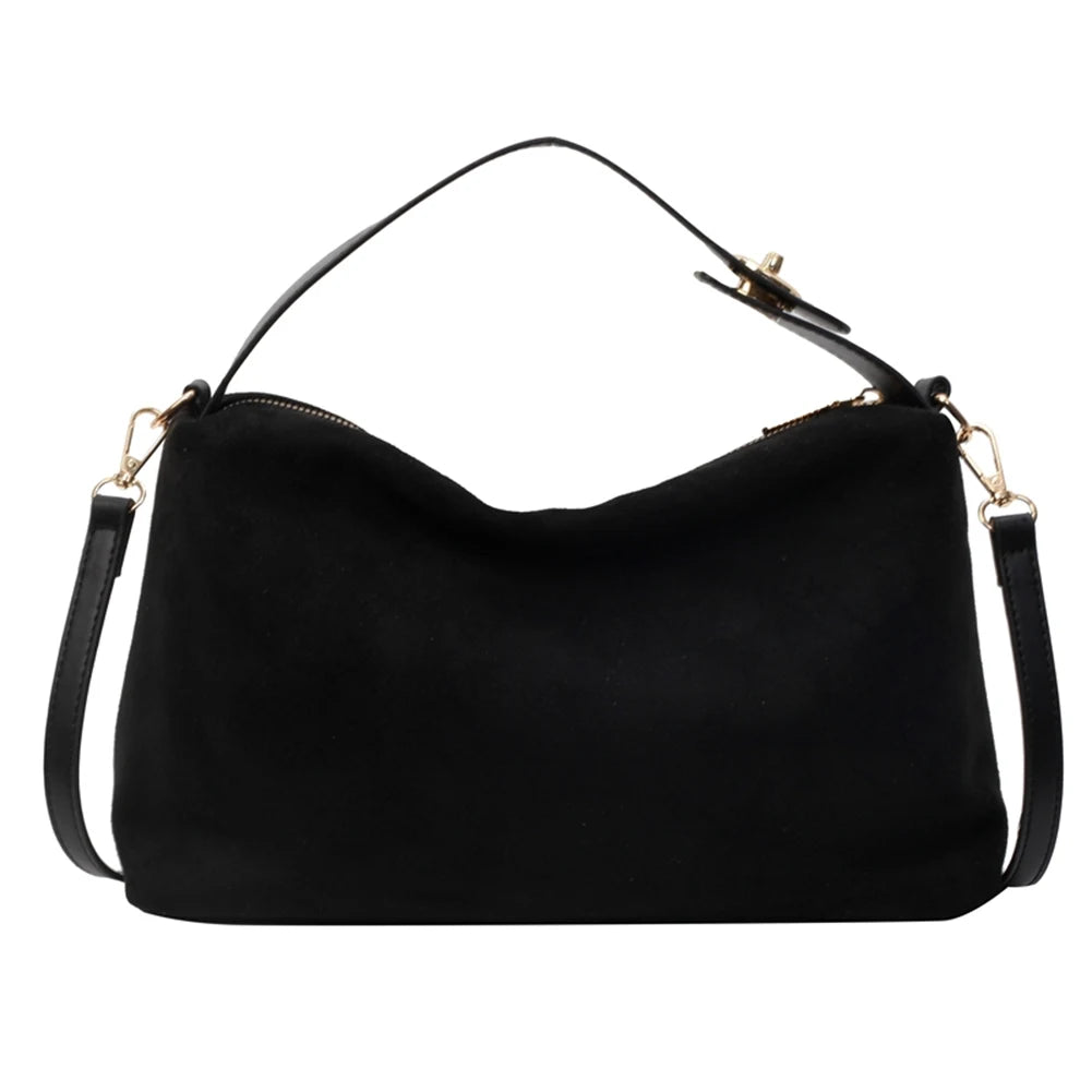Black shoulder bag with gold hardware on a white background