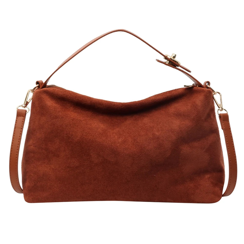 Brown suede handbag with shoulder strap on a white background