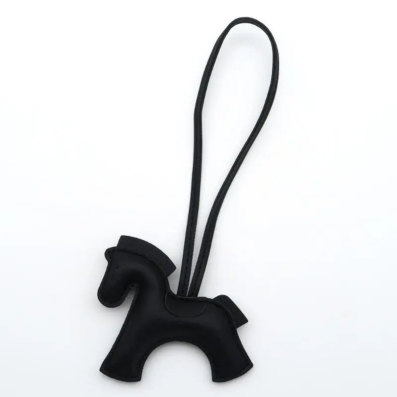 Black horse-shaped keychain with a strap on a white background