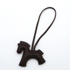 Brown horse-shaped keychain on a white background