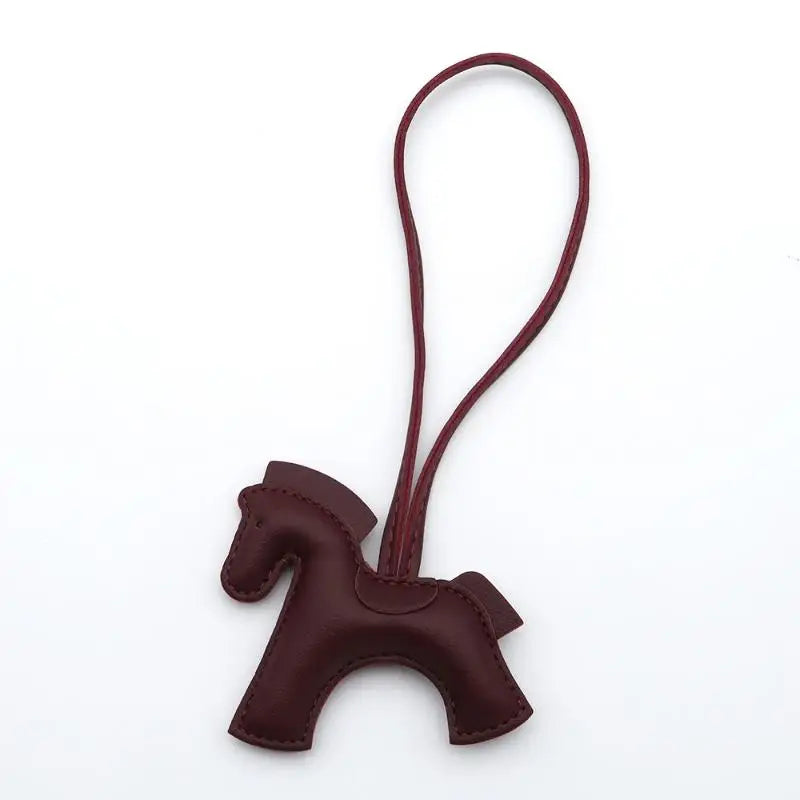 Brown horse-shaped keychain on a white background