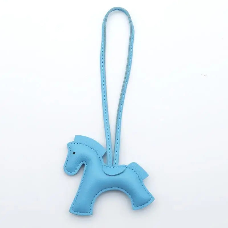 Blue horse-shaped keychain on a white background