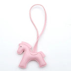 Pink horse-shaped keychain on a white background