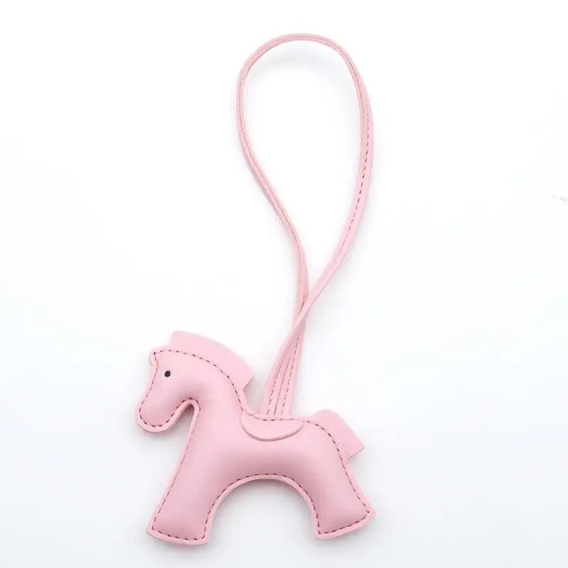 Pink horse-shaped keychain on a white background