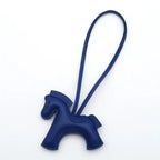 Navy blue horse-shaped keychain on a white background