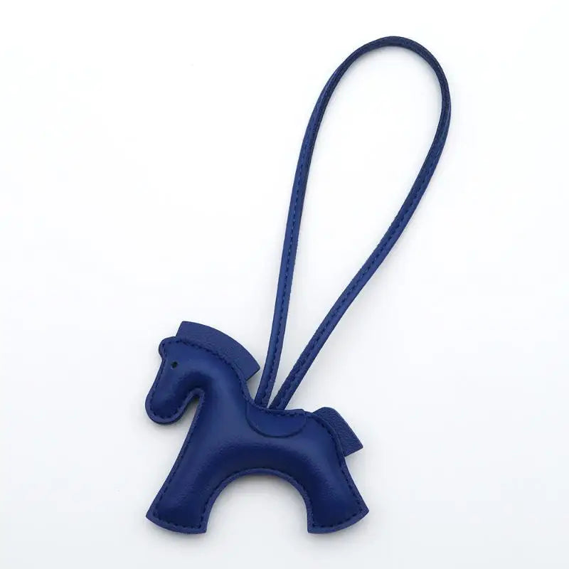Navy blue horse-shaped keychain on a white background