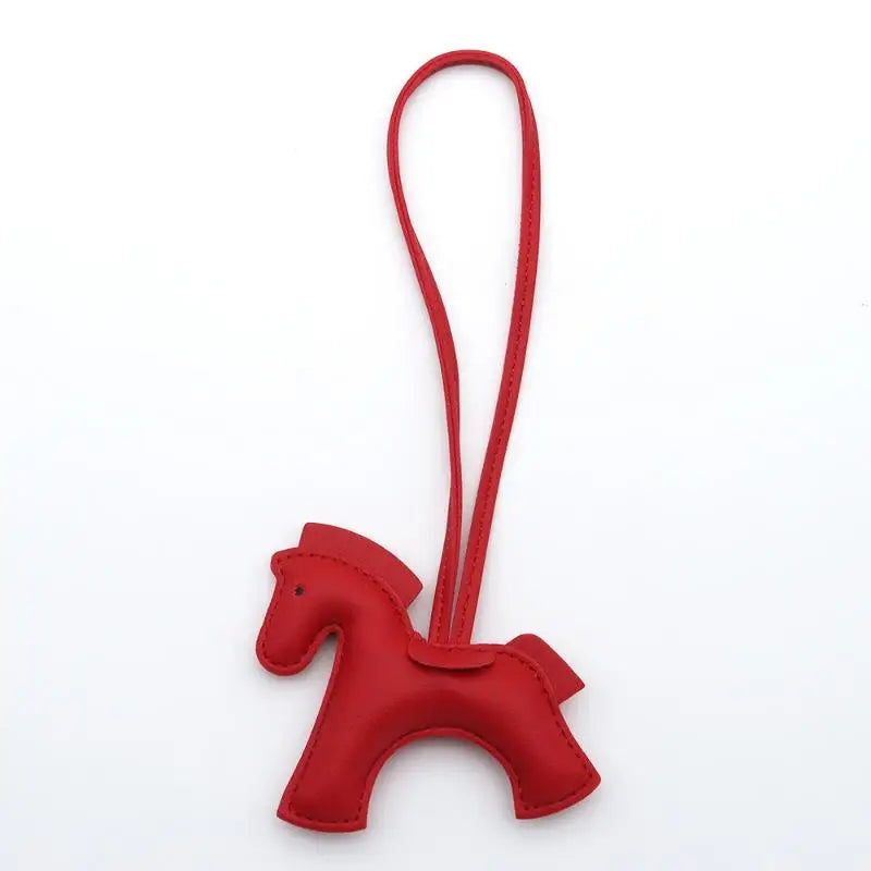 Red horse-shaped keychain with a strap on a white background