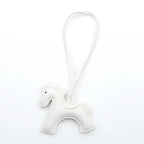 White horse-shaped keychain on a white background