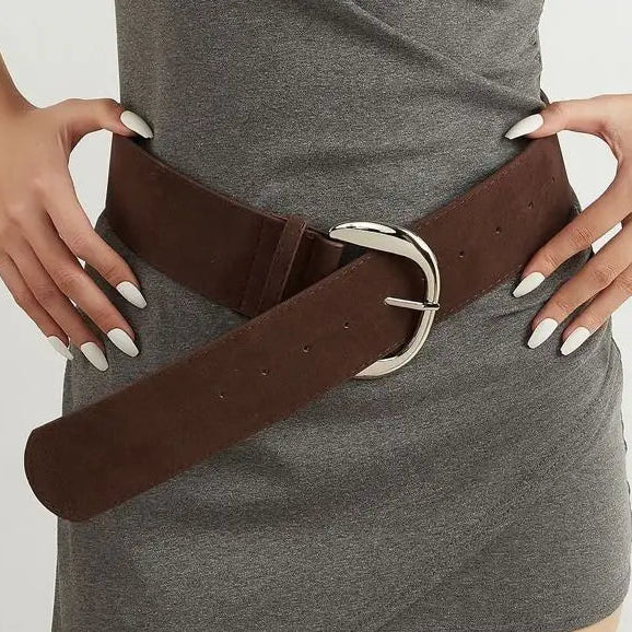 Woman wearing a brown belt with a gray dress, surrounded by various belt colors on a white background.