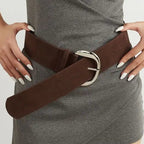 Woman wearing a brown belt with a gray dress, surrounded by various belt colors on a white background.