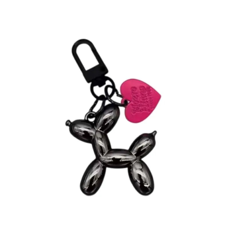 Keychain shaped like a balloon dog with a pink heart tag on a white background