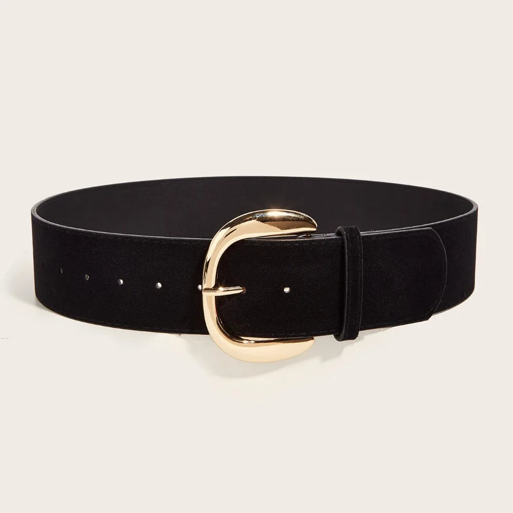 Black belt with a gold buckle on a beige background