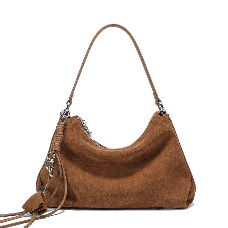 Brown handbag with a strap on a white background