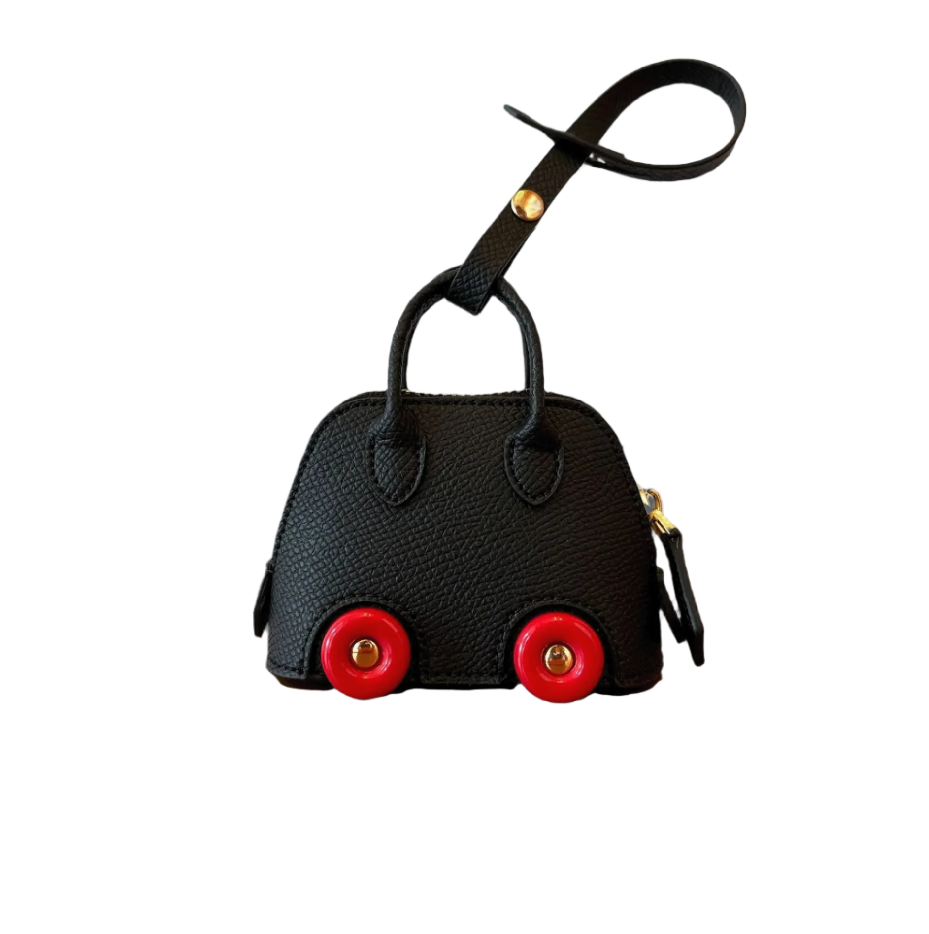 Black leather car shape bag charm with red wheels and top handle. Handbag accessory and keychain.