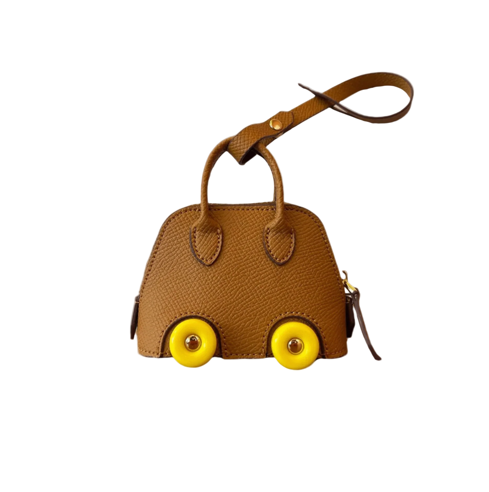 Gold or brown colored leather car shape bag charm with yellow wheels and top handle. Handbag accessory and keychain.