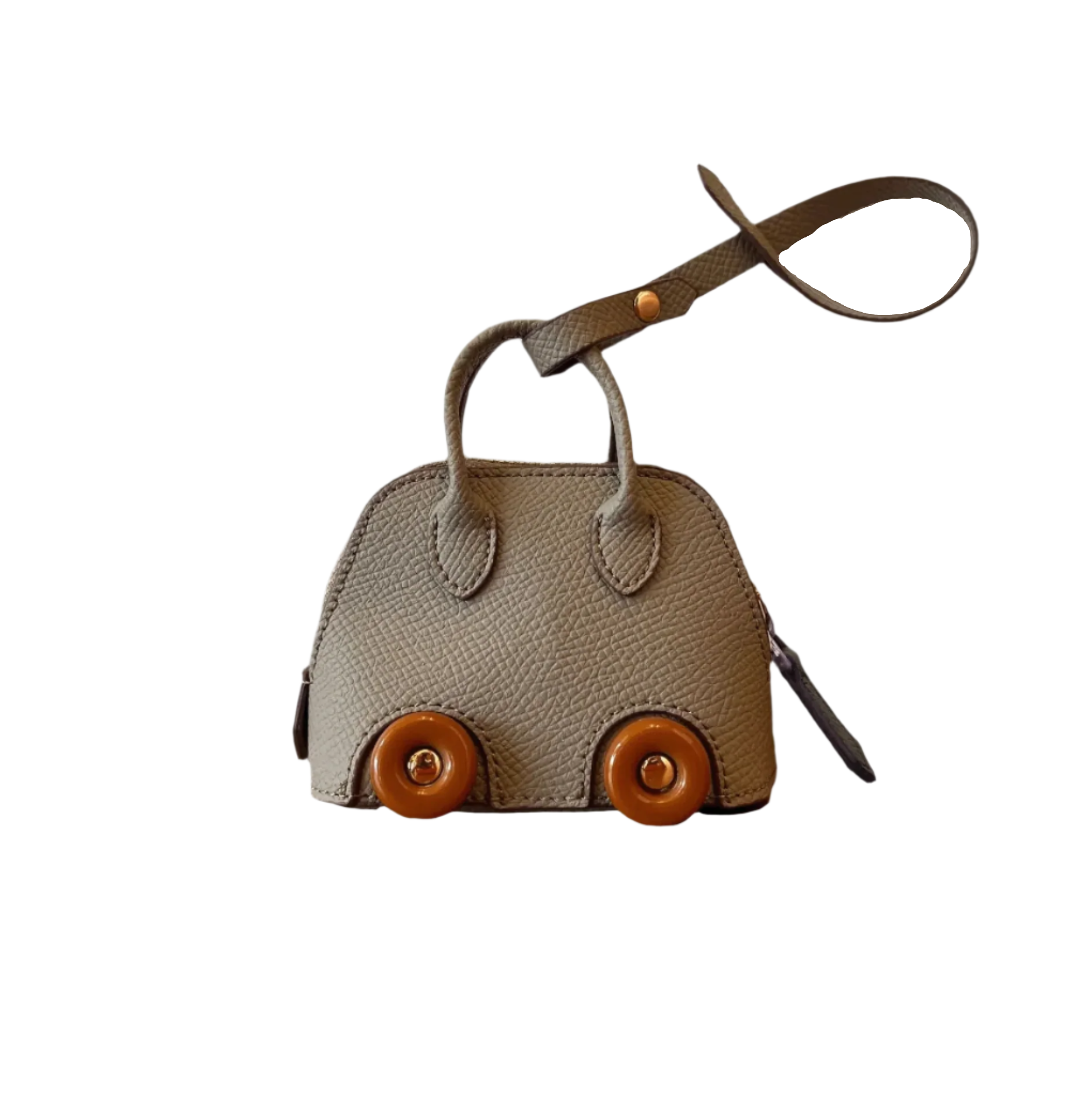 Gray leather car shape bag charm with brown wheels and top handle. Handbag accessory and keychain.
