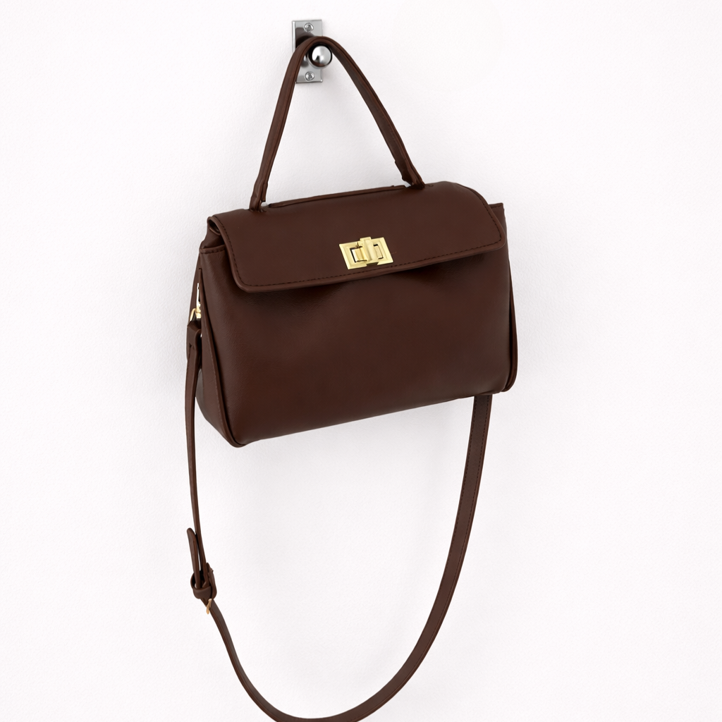 Brown handbag with a gold clasp on a white background