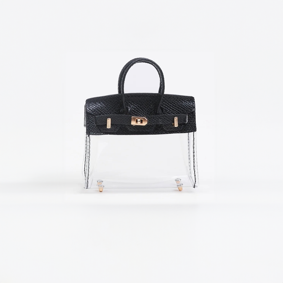 Black top handle and base, clear panel structured mini bag charm with gold-tone hardware.