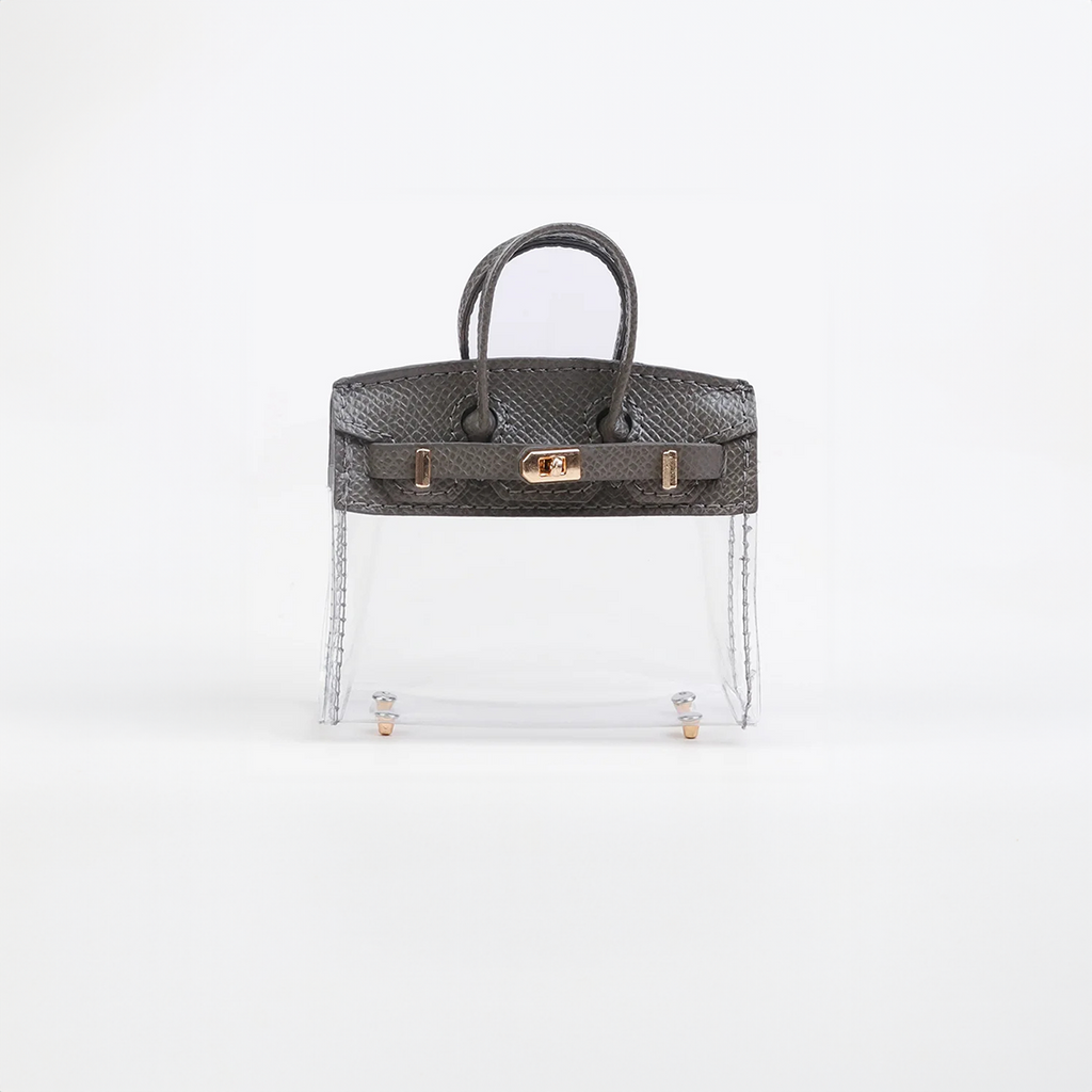 Gray top handle and base, clear panel structured mini bag charm with gold-tone hardware.