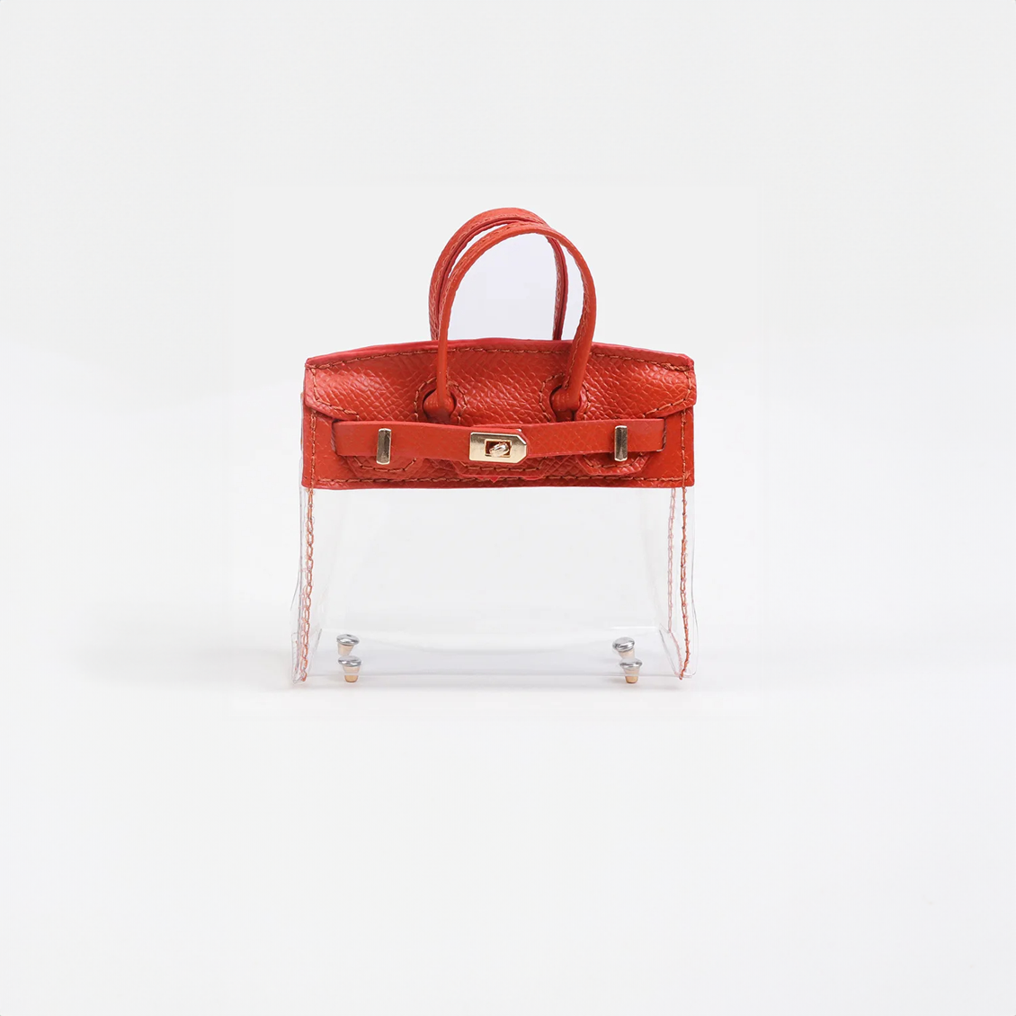 Red top handle and base, clear panel structured mini bag charm with gold-tone hardware.