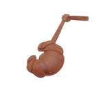 Brown leather crossiant bag charm on a white background