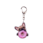 Keychain with a dog holding a pink donut on a white background