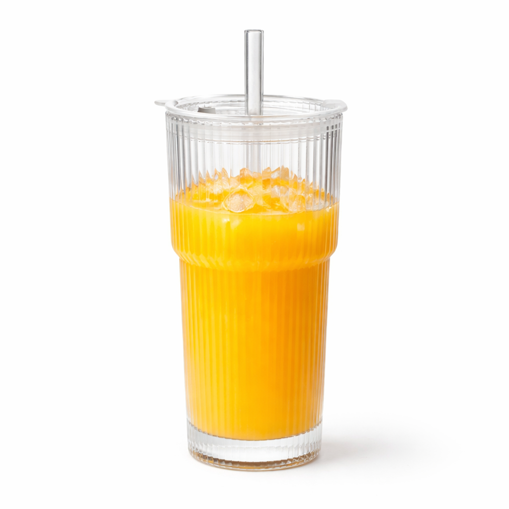Clear glass with orange juice and ice cubes on a white background