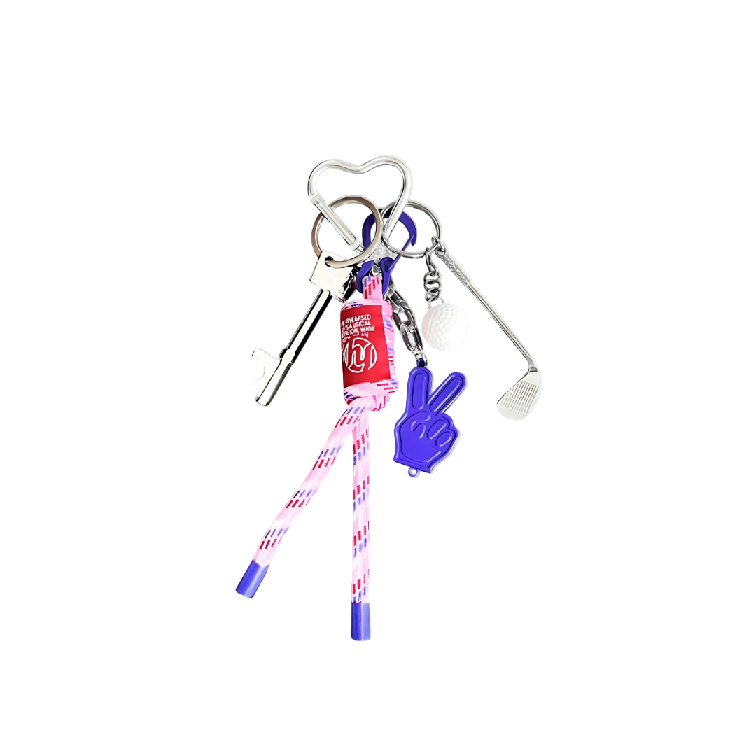 Keychain charm featuring a white golf ball, golf club, and a bright purple V-sign/Peace Sign charm, linked with patterned pink and purple cords.