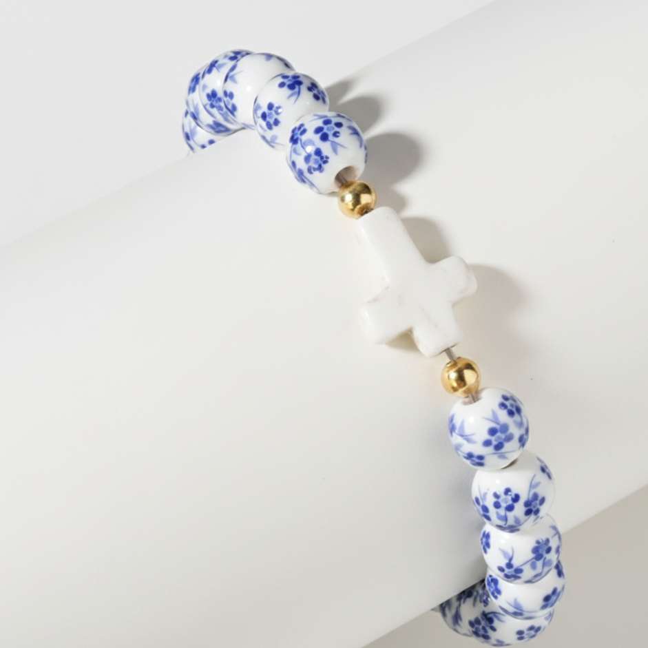 Beaded necklace with blue floral pattern on a white background