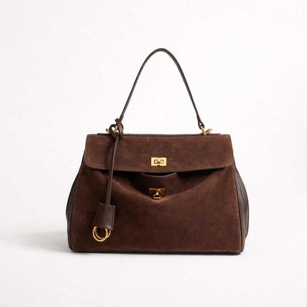 Brown handbag with gold accents on a white background
