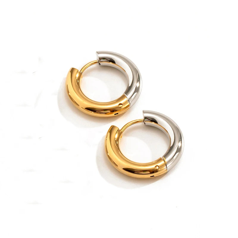 Two gold hoop earrings on a white background