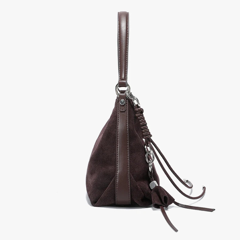 Brown leather handbag with a strap on a white background