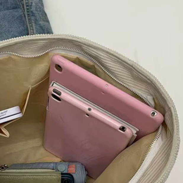 Pink phone case inside a beige bag with a white background